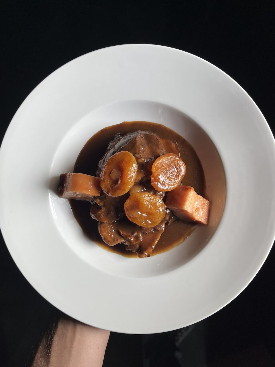 Pork cheeks braised with apricots and smoked bacon